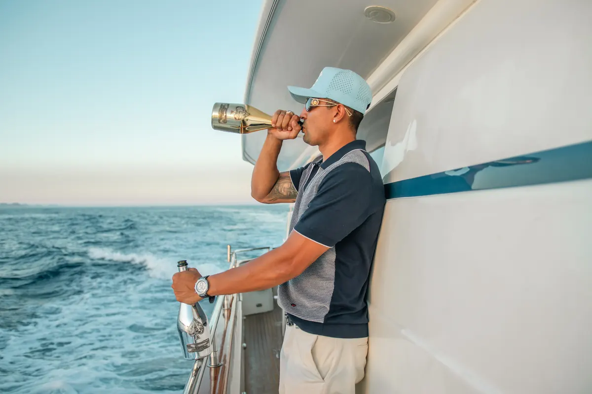 Popping champagne on the Cabo party yacht